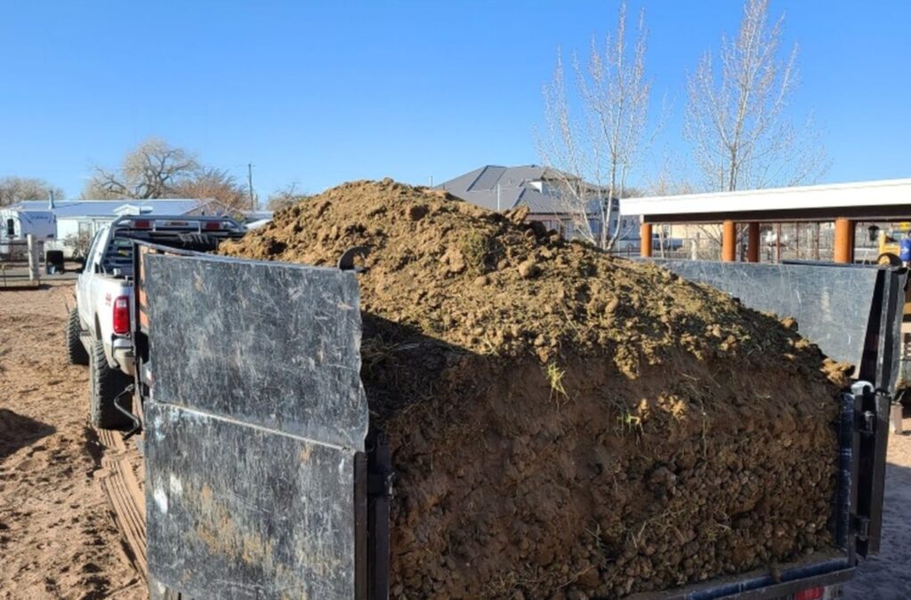 A Hauling 24/7 team member clearing dirt and gravel in Santa Barbara, CA, ensuring a clean and debris-free property.