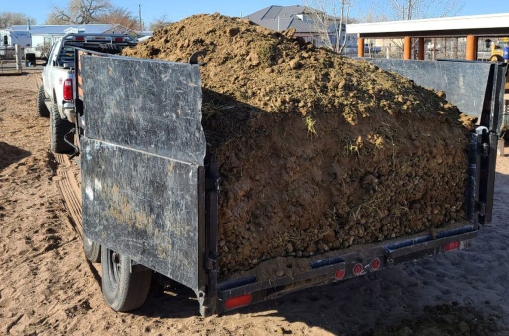 A Hauling 24/7 employee providing expert dirt and gravel removal services in Goleta, CA using heavy machinery for efficient job completion.