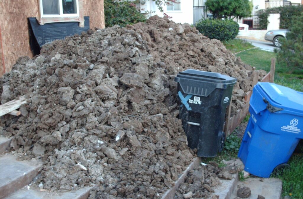 A Hauling 24/7 expert handling a dirt and gravel removal task in Goleta, CA, illustrating expertise and dedication to clean outcomes. Dirt and Gravel Removal near me.