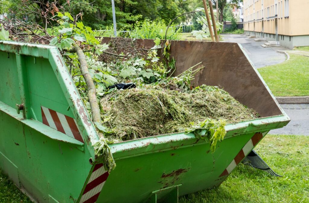 A Hauling 24/7 team member performing green waste removal in Goleta, CA, highlighting the importance of using a local professional for effective waste solutions.